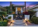 Close up of the front entrance with an artistic gate and landscaped surroundings at 2355 Villandry Ct, Henderson, NV 89074