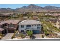 Aerial view of a two-story home with a tile roof, surrounded by a landscaped yard in a residential community at 257 Elder View Dr, Las Vegas, NV 89138