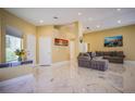 Spacious living room featuring marble floors, recessed lighting, and modern decor at 2608 Port Of Call Dr, Las Vegas, NV 89128