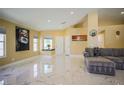 Bright living room featuring marble floors, recessed lighting, and artwork at 2608 Port Of Call Dr, Las Vegas, NV 89128