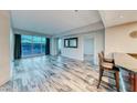 Open living area features wood floors, large windows with a city view, and bar seating at 2700 Las Vegas Blvd # 3501, Las Vegas, NV 89109