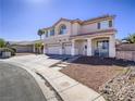Two-story home with three-car garage, covered front porch, and well-maintained landscaping at 2743 Peekskill Ave, Henderson, NV 89052