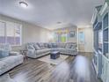 Bright living room with a large sectional sofa, stylish decor, and hardwood floors at 2743 Peekskill Ave, Henderson, NV 89052