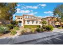 Beautiful two-story home with a tile roof, well-maintained lawn, and shade trees at 2894 Carmelo Dr, Henderson, NV 89052
