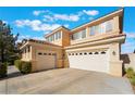 Spacious three-car garage with a paved driveway and well-manicured landscaping at 2894 Carmelo Dr, Henderson, NV 89052