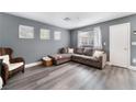 Cozy living room with modern gray walls and stylish gray wood flooring at 3103 Sunrise Cove Ave, North Las Vegas, NV 89031