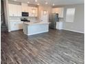 Bright and airy kitchen with stainless appliances, hardwood floors and center island at 3481 Bradano Ln, Henderson, NV 89044