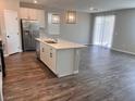 Spacious kitchen with a center island, stainless steel appliances, and hardwood floors at 3481 Bradano Ln, Henderson, NV 89044