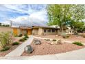 Charming single-story home with desert landscaping and a walkway leading to a bright yellow front door at 3597 Cochise Ln, Las Vegas, NV 89169