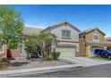 Attractive two-story home with a two-car garage, xeriscaping, and mature trees in a suburban neighborhood at 3744 Alpine Bypass Ave, North Las Vegas, NV 89081