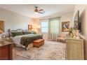 Spacious main bedroom with a decorative ceiling fan, plush rug, and elegant furnishings at 408 Middlestone Ave, Henderson, NV 89011