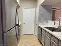 Modern kitchen with stainless steel appliances, light gray cabinets, and tile backsplash at 45 Maleena Mesa St # 1113, Henderson, NV 89074