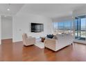 Spacious living room with floor-to-ceiling windows, sleek hardwood floors, and stylish contemporary furniture at 4525 Dean Martin Dr # 3006, Las Vegas, NV 89103