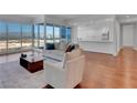 Open concept living space with floor-to-ceiling windows offering city views, connected to kitchen at 4525 Dean Martin Dr # 3006, Las Vegas, NV 89103