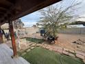 Spacious backyard with a mix of artificial and natural grass, and mature landscaping at 4825 E Monroe Ave, Las Vegas, NV 89110