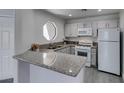 Well-maintained kitchen featuring ample counter space and modern white appliances at 5032 S Rainbow Blvd # 206, Las Vegas, NV 89118