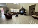 Spacious living room boasts high ceilings, tile floors, and an entertainment center at 5615 Oak Bend Dr, Las Vegas, NV 89135