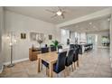 Open dining area with natural light, leading to a modern white kitchen at 5892 Castleberry Peak Ave, Las Vegas, NV 89131