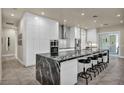 Bright kitchen with sleek white cabinetry, black marble island, and stainless steel appliances at 5892 Castleberry Peak Ave, Las Vegas, NV 89131