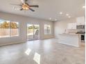 Open concept living space with a kitchen and lots of natural light from large windows at 6164 Violet Falls St # 44, North Las Vegas, NV 89081