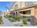 Street view showcasing well-maintained townhouses with manicured landscaping at 6239 Milford Sound St, Las Vegas, NV 89148