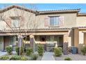 Charming townhouse featuring a well-manicured front yard and attractive architectural details at 6239 Milford Sound St, Las Vegas, NV 89148