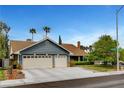Charming single-story home with a well-manicured lawn, mature trees and a two car garage at 6304 Peppermill Dr, Las Vegas, NV 89146