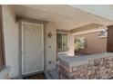 Inviting covered front porch with stone accents and decorative security door provides a warm welcome at 6620 Macdoogle St, Las Vegas, NV 89166