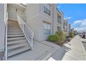 Exterior stairs lead to upper level apartment homes with well-maintained landscaping at 6800 E Lake Mead Blvd # 2050, Las Vegas, NV 89156