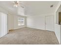Spacious living room with neutral carpet, ceiling fan, and lots of natural light at 6800 E Lake Mead Blvd # 2050, Las Vegas, NV 89156