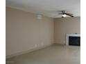 Spacious living room featuring tile floors and a cozy fireplace at 7170 Mountain Moss Dr, Las Vegas, NV 89147