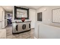 Hallway featuring a modern accent cabinet, neutral walls, and views into the bedroom at 7250 Diamond Canyon Ln # 204, Las Vegas, NV 89149