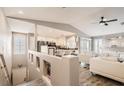 Open-concept living area featuring a staircase, luxury vinyl floors, and views into the kitchen at 7250 Diamond Canyon Ln # 204, Las Vegas, NV 89149