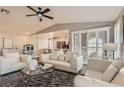 Bright living room with white seating, a ceiling fan, and a view into the kitchen at 7250 Diamond Canyon Ln # 204, Las Vegas, NV 89149