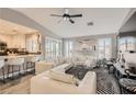 Bright living room with neutral walls, luxury vinyl floors, and views into the kitchen at 7250 Diamond Canyon Ln # 204, Las Vegas, NV 89149