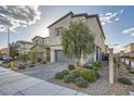 Inviting two-story home with a paved driveway, complemented by a neatly landscaped front yard at 7605 Moore Creek Ln, North Las Vegas, NV 89084