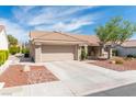 Single-story home featuring a two-car garage and low-maintenance desert landscaping in the front yard at 8812 Marble Dr, Las Vegas, NV 89134