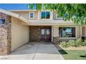 Inviting home entrance with double doors, stone accents, and manicured landscaping at 902 Dianne Dr, Boulder City, NV 89005