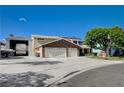 Spacious home with a large three-car garage, RV parking, and well-manicured landscaping at 902 Dianne Dr, Boulder City, NV 89005