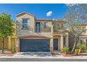 Charming two-story home featuring a blue garage door and a second-story balcony at 9066 Hilverson Ave, Las Vegas, NV 89148