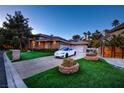 Beautiful exterior with a well-maintained lawn, a white car, and an attached two-car garage at 3008 Astoria Pines Cir, Las Vegas, NV 89107