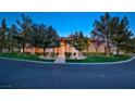 Elegant front exterior shows manicured lawn, mature trees and inviting walkway to the main entrance at 3008 Astoria Pines Cir, Las Vegas, NV 89107