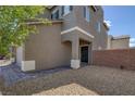 Home exterior displaying entryway, desert landscaping, and a two-car garage at 5589 Pico Ferrera Ct, Las Vegas, NV 89113
