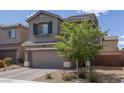 Charming exterior showcasing a two-story home with a lovely front yard at 5589 Pico Ferrera Ct, Las Vegas, NV 89113