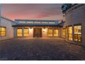 Stunning home exterior featuring an arched double-door entrance and a spacious stone paved drive at 6861 E Washington Ave, Las Vegas, NV 89110