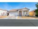 Charming single-story home with a well-maintained front yard and two-car garage at 8276 Aurora Peak Ave, Las Vegas, NV 89131