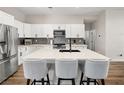 Spacious kitchen with stainless steel appliances, a large island with seating, and white cabinetry at 8276 Aurora Peak Ave, Las Vegas, NV 89131