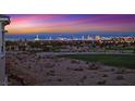 Picturesque cityscape view at sunset with vibrant colors painting the sky overlooking a golf course at 9213 Las Manaitas Ave # 401, Las Vegas, NV 89144