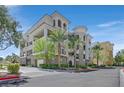 Beautiful multi-story condo building featuring a stucco exterior, and a well-manicured landscaped entrance at 9213 Las Manaitas Ave # 401, Las Vegas, NV 89144