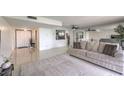 Spacious living room with sleek tile floors, large sofa, and mirrored wall that enhances the space at 205 E Harmon Ave # 803, Las Vegas, NV 89169